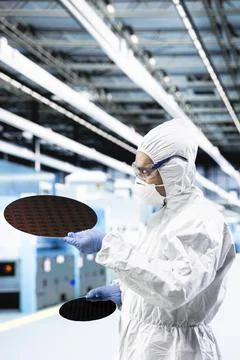 Close up of man doing quality control on silicon wafers Stock Photos