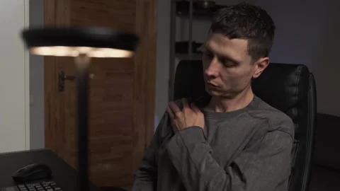 Close up man doing self massage at computer desk home office chair self care Stock Footage 315412040