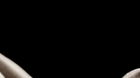 Close up of man doing sit ups and sweating in a dark studio Stock Footage 33830914