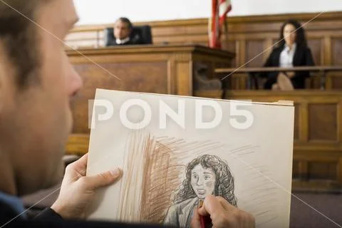 Close-up of a man drawing a sketch of a witness in a courtroom Stock Photos