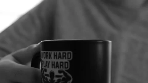 A close up of a man drinking cup of tea in a mug black and white. Stock Footage 155127358