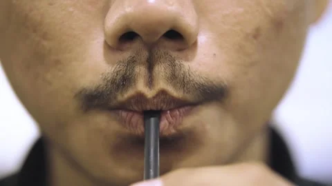 Close-Up of Man Drinking Through a Straw. Macro Shot of Male Lips Sipping f.. Stock Footage 312370438