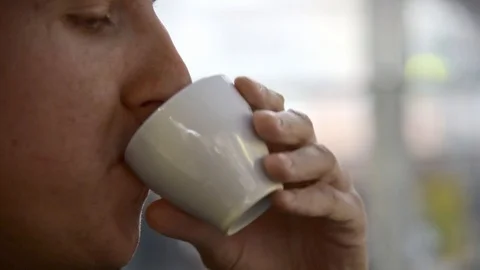 Close up man drinks espresso in the caffeteria. Video stock 119793702