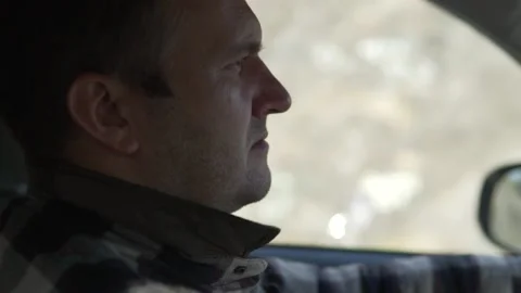 A close-up man drives a car Stock Footage 140576945