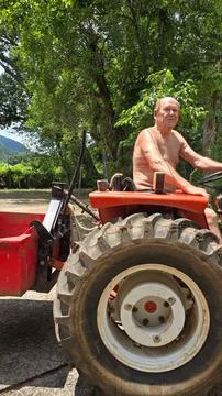 Close up of man driving tractor Stock Photos