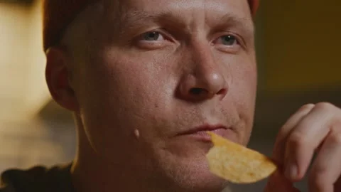 Close up of man during mindful evening snacking ritual 動画素材 320137849
