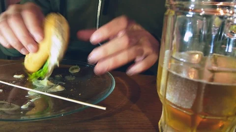 Close-up. A man is eating a burger. The process of eating delicious burgers. Stock Footage 96043497