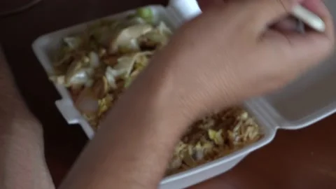 Close up of a man eating chaufa, typical Peruvian fast food Stock Footage 149192831