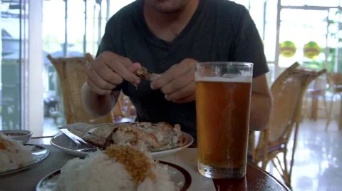 Close up of man eating fish and drinking beer Stock Footage 68679532