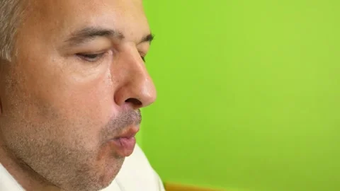 Close-up of a man eating a piece of fresh fruit with a fork during a meal at  Stock Footage 337883658