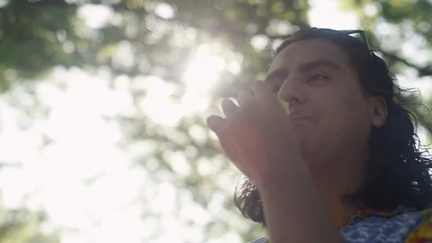 Close-up of a man eating potato chips at a backyard barbeque Video stock 116803209