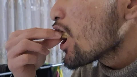 Close-up of a man eating sweet dates Stock Footage 329748522