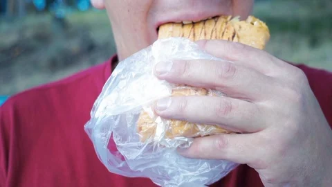 Close-up, man eats, fast food, doner kebab, pita, shawarma. Stock-Footage 93896949