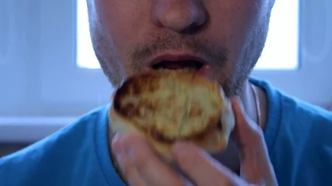 Close-up, man eats, fast food, a national dish, pie, unshaven man Stock Footage 94068500