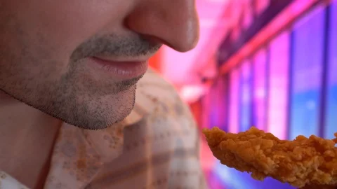 Close-up, man eats, fast food, chicken nuggets, wings and french fries modern Stock Footage 101916961
