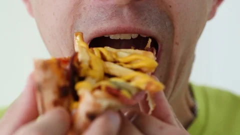 Close up man eats with great pleasure, man eats pizza, food. Stock-Footage 128452665