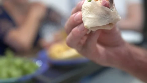 Close-up. A man eats shawarma at home in the kitchen Stock Footage 112332584