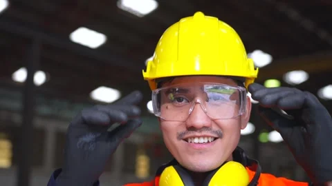 Close up man engineer wearing and adjust protective safety helmet or hard hat. Stock Footage 332119419