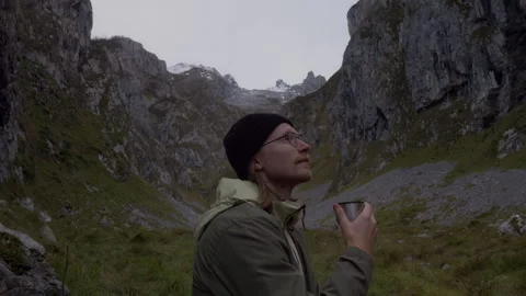 Close-up of man enjoying hot drink in scenic mountain wilderness Stock Footage 336726718