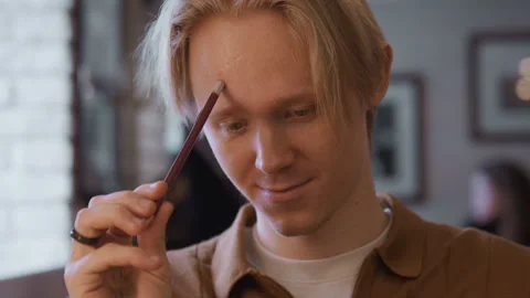 Close up man examining interesting closeup object in soft light indoors Stock Footage 344870342