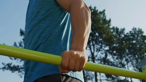 Close up of a man exercising on parallel bars Stock Footage 100031372