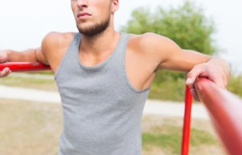 Close up of man exercising on parallel bars 写真素材