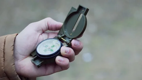 Close up of man explorer searching direction with compass in winter forest Stock Footage 84677668
