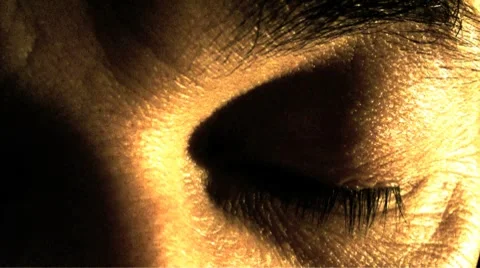 A close-up of man eye closed, then suddenly opened Stock Footage 7729547