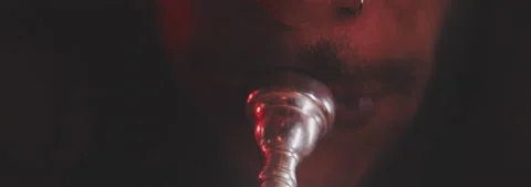 Close up of a man face while playing the trumpet Stock Footage 202320054