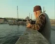 Close up of man fishing off bridge SD Footage