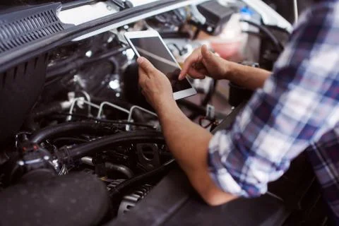 Close up of a man fixing broken car engine. Stock Photos