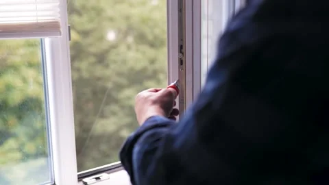 Close up of a man fixing or repairing a plastic window frame with a screwdriv Stock Footage 340159542