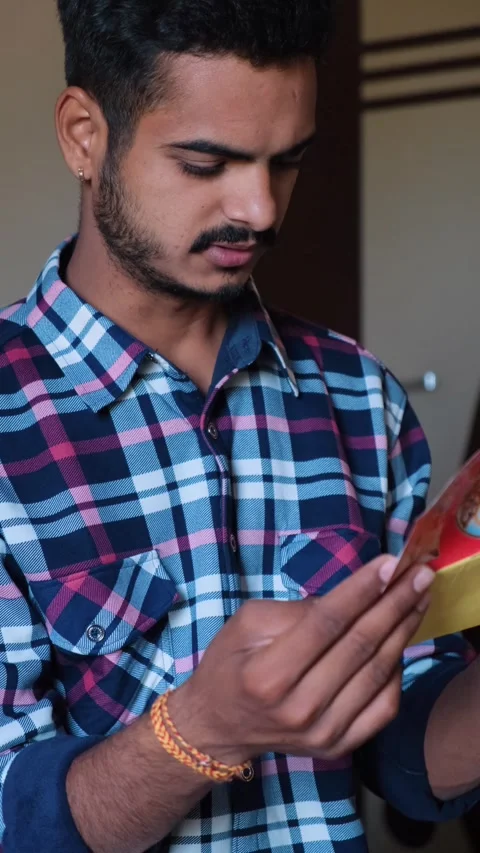 Close-up of a man focusing on reading printed information, indoors 스톡 동영상 331354499