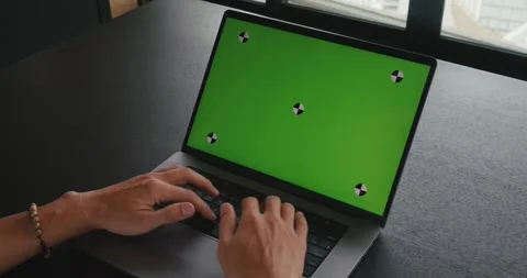 Close up man freelancer working at laptop computer with green screen mock-up Stock Footage 250580141