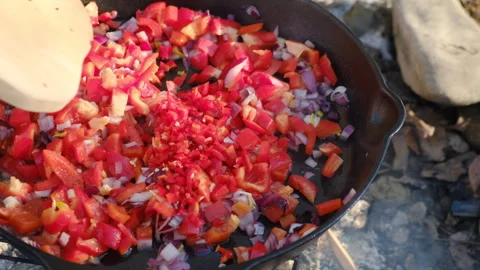 Close up of man fries vegetables in pan at winter outdoors Stock Footage 301364019