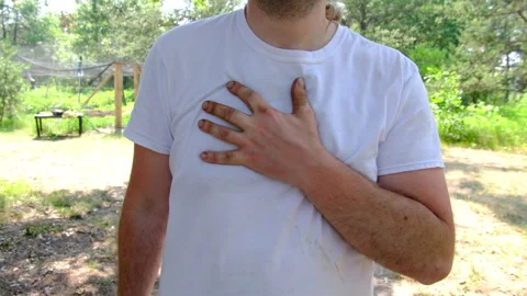 Close up of man gentle massaging his right side chest with slightly dirty hand Vídeos de archivo 244629090