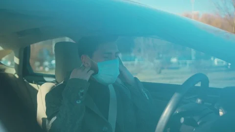 Close up man gets in the car coughs removes Protective Face Mask COVID-19 Stock Footage 126618098