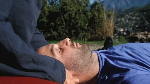 Close-up of a man getting ear massage outdoors 스톡 동영상 229837064