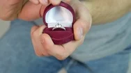 Close Up Of Man With Gift Box And Engagement Ring Over Holidays Lights Stock Footage