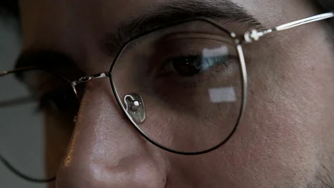 Close-Up Of a man with Glasses Using a Computer, Watching news Stock Footage 144685143