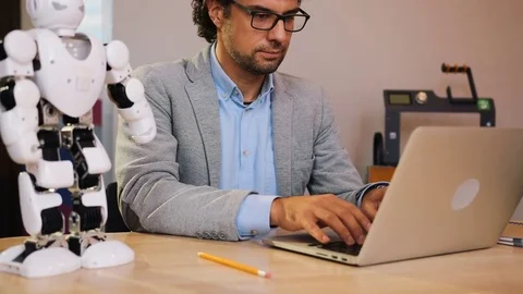 Close up of man in glasses working on his laptop and poses in the camera in the Stock Footage 82498650