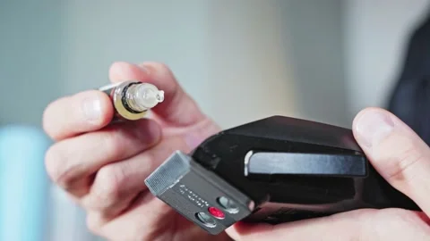 Close-up of a man greasing a clipper with machine oil. Stock Footage 224973230