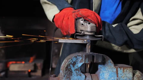 A close-up of a man grinding with a grinding machine a metal angular profile Stock Footage 205065228