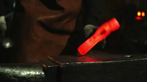 Close-up, a man with a hammer hits the hot metal Stock Footage 143462469
