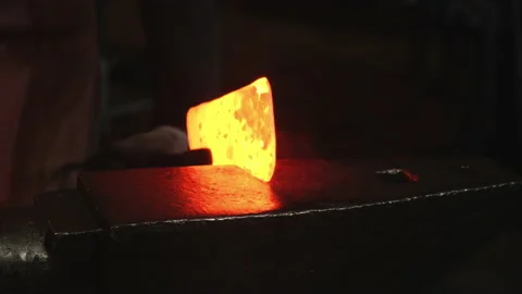 Close-up, a man with a hammer hits the hot metal Stock Footage 143462898