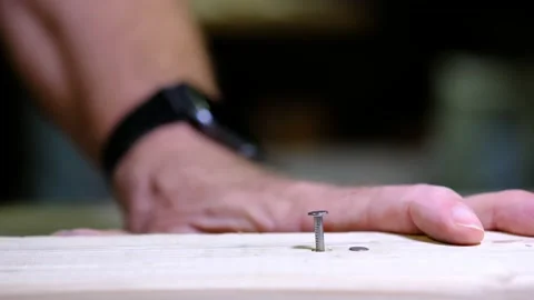 Close up of a man hammering a nail Stock Footage 139015689