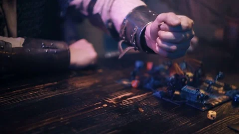 Close up of man hand in armor dropping coins near fantasy board game Stock Footage 79440705
