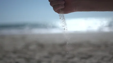Close man hand at the beach, holding beach sand and open slowly Stock Footage 100165602