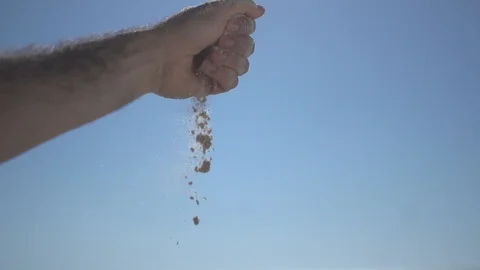 Close man hand at the beach, holding beach sand and open slowly Stock Footage 100165915