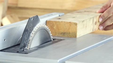 Close-up man hand carpenter sawing wooden with electric saw table Stock Footage 138681485